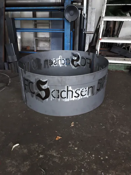 Runde Metallschale mit ausgeschnittenem Schriftmotiv